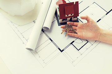 Image showing close up of hand with house keys and blueprint