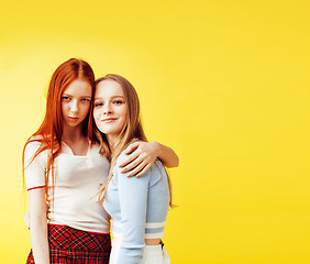 Image showing lifestyle people concept: two pretty young school teenage girls having fun happy smiling on yellow background 