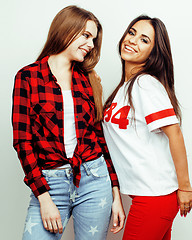 Image showing best friends teenage girls together having fun, posing emotional on white background, besties happy smiling, lifestyle people concept, blond and brunette multi nations 