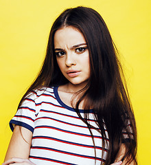 Image showing lifestyle people concept: pretty young school teenage girl having fun happy smiling on yellow background