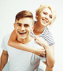 Image showing young pretty teenage couple, hipster guy with his girlfriend happy smiling and hugging isolated on white background, lifestyle people concept closeup