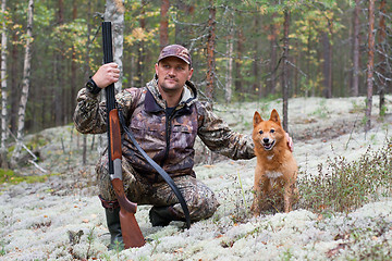 Image showing hunter stroking his dog