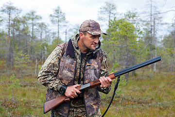 Image showing hunter waiting for prey on the swamp