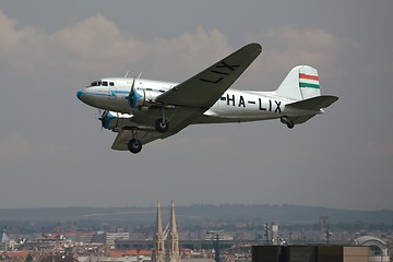 Image showing Old aircraft over a city