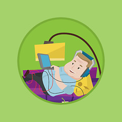 Image showing Man lying on sofa with many gadgets.