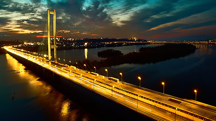 Image showing Automobile and railroad bridge in Kiev, the capital of Ukraine. Bridge at sunset across the Dnieper River. Kiev bridge against the backdrop of a beautiful sunset in Kiev. Bridge in evening sunshine