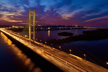 Image showing Automobile and railroad bridge in Kiev, the capital of Ukraine. Bridge at sunset across the Dnieper River. Kiev bridge against the backdrop of a beautiful sunset in Kiev. Bridge in evening sunshine