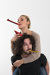 Image showing couple in party hats blowing in whistle