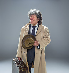 Image showing The senior man as detective or boss of mafia on gray studio background