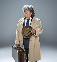 Image showing The senior man as detective or boss of mafia on gray studio background