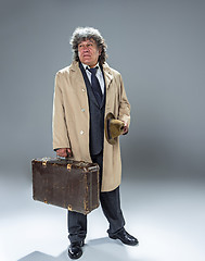 Image showing The senior man as detective or boss of mafia on gray studio background