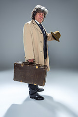 Image showing The senior man as detective or boss of mafia on gray studio background