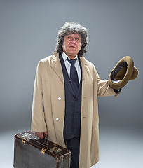 Image showing The senior man as detective or boss of mafia on gray studio background