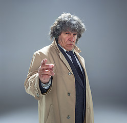 Image showing The senior man as detective or boss of mafia on gray studio background