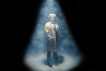 Image showing The senior man as detective or boss of mafia on gray studio background