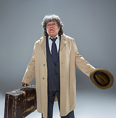 Image showing The senior man as detective or boss of mafia on gray studio background