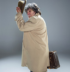 Image showing The senior man as detective or boss of mafia on gray studio background