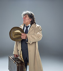 Image showing The senior man as detective or boss of mafia on gray studio background