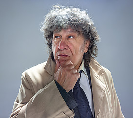 Image showing The senior man as detective or boss of mafia on gray studio background