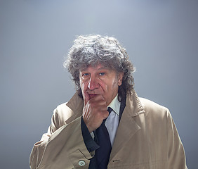 Image showing The senior man as detective or boss of mafia on gray studio background