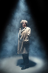 Image showing The senior man as detective or boss of mafia on gray studio background