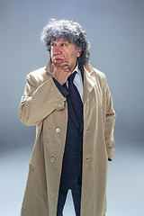 Image showing The senior man as detective or boss of mafia on gray studio background