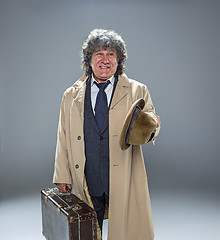 Image showing The senior man as detective or boss of mafia on gray studio background