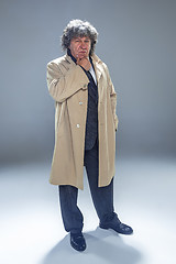 Image showing The senior man as detective or boss of mafia on gray studio background