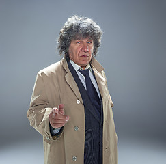 Image showing The senior man as detective or boss of mafia on gray studio background