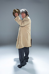 Image showing The senior man as detective or boss of mafia on gray studio background