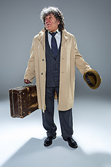 Image showing The senior man as detective or boss of mafia on gray studio background