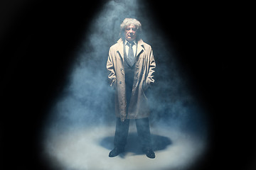 Image showing The senior man as detective or boss of mafia on gray studio background