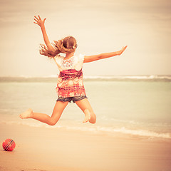 Image showing Happy teen girl  jumping on the beach