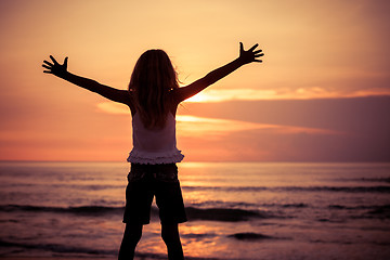 Image showing Happy little girl  standing on the beach