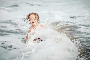 Image showing Portrait of little boy standing on the beach