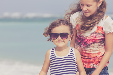 Image showing Sister and brother playing on the beach at the day time.