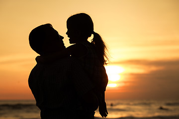 Image showing Father and daughter playing on the beach at the day time.