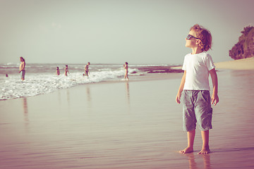 Image showing Happy little boy playing on the beach 