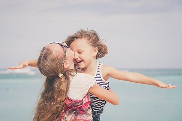 Image showing Sister and brother playing on the beach at the day time.