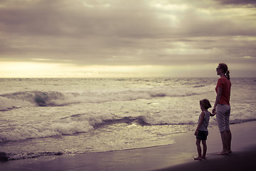 Image showing Mother and son playing on the beach at the day time.