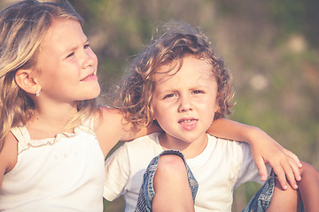 Image showing Sister and brother playing on the beach at the day time.