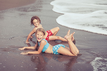 Image showing Sister and brother playing on the beach at the day time.