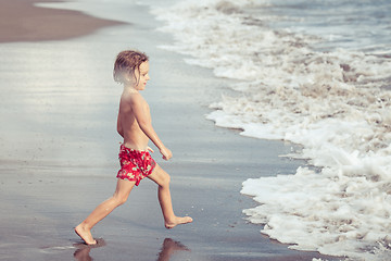 Image showing Portrait of little boy standing on the beach