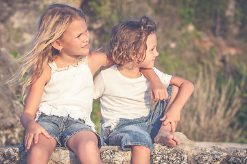 Image showing Sister and brother playing on the beach at the day time.