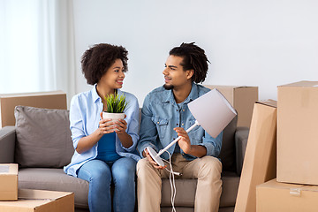 Image showing happy couple with stuff moving to new home