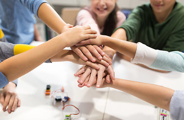 Image showing happy children holding hands at robotics school