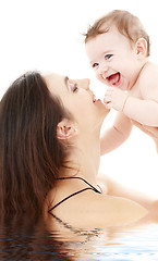Image showing laughing blue-eyed baby playing with mom