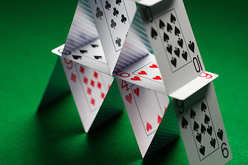 Image showing close up of house of playing cards on green cloth