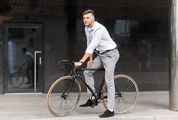 Image showing man with bicycle and headphones on city street