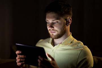 Image showing young man with tablet pc computer at night